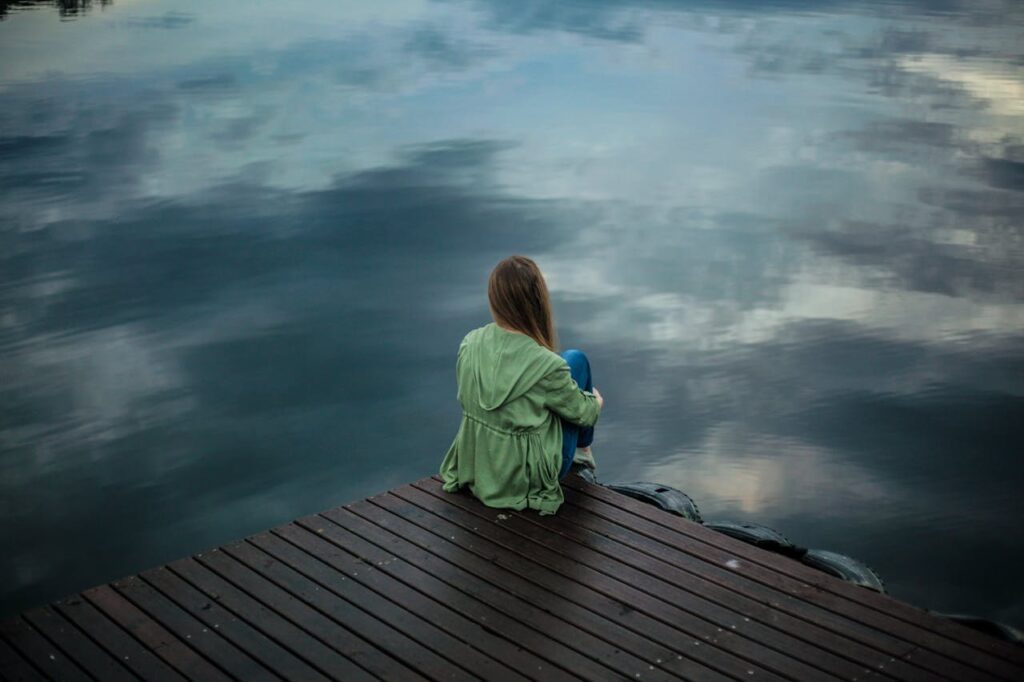woman-sitting-near-the-water-depressed